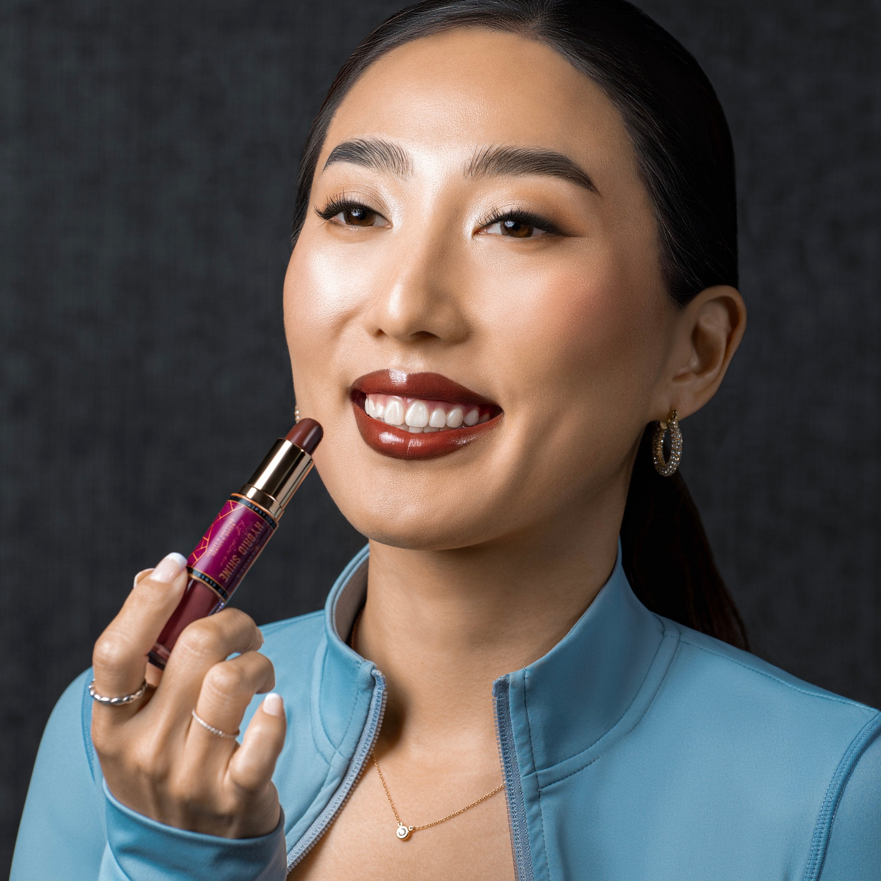Model wearing brown lipstick and nude gloss over it - its the Cannes Hybrid Shine - Lipgloss and Lipstick  Duo Loola Cosmetics